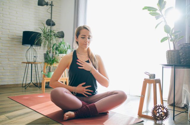 woman doing yoga breathing indoors