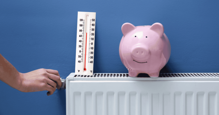 piggy bank on heater next to thermometer