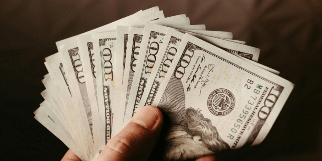 Person holding thousands of dollars in HVAC savings