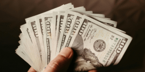 Person holding thousands of dollars in HVAC savings