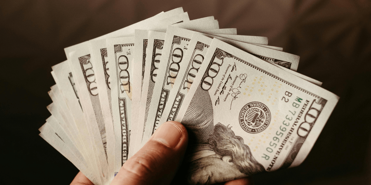 Person holding thousands of dollars in HVAC savings